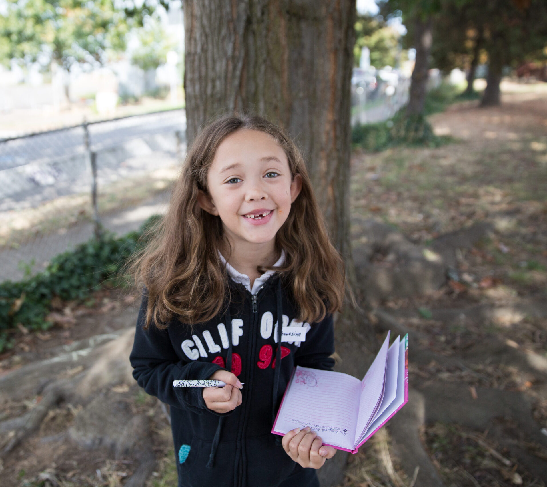 girl with notebook outdoors