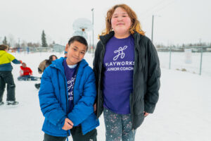 to kids smiling with snowy background