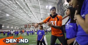 Broncos player with children