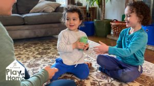 children and adult playing game at home