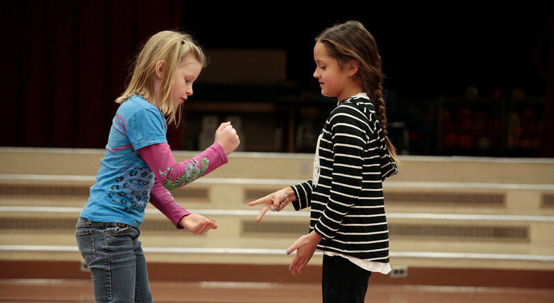 two girls playing rock paper scissors