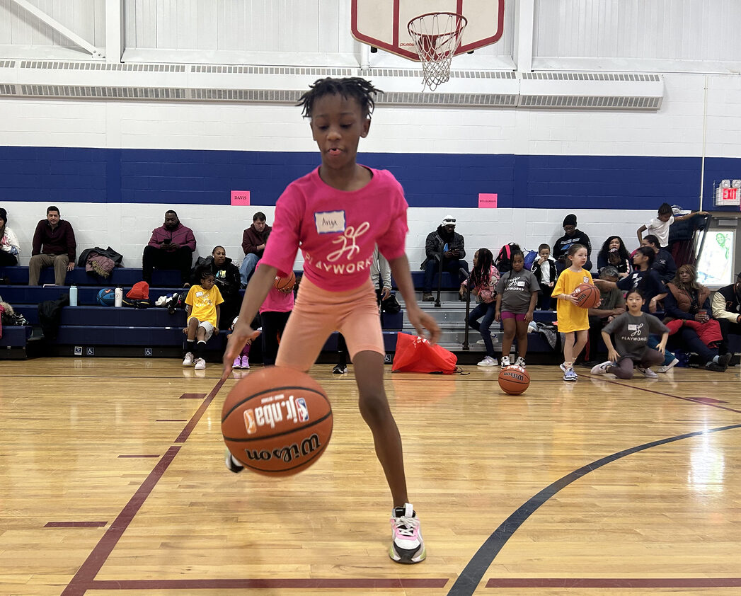 girl dribbling basketball