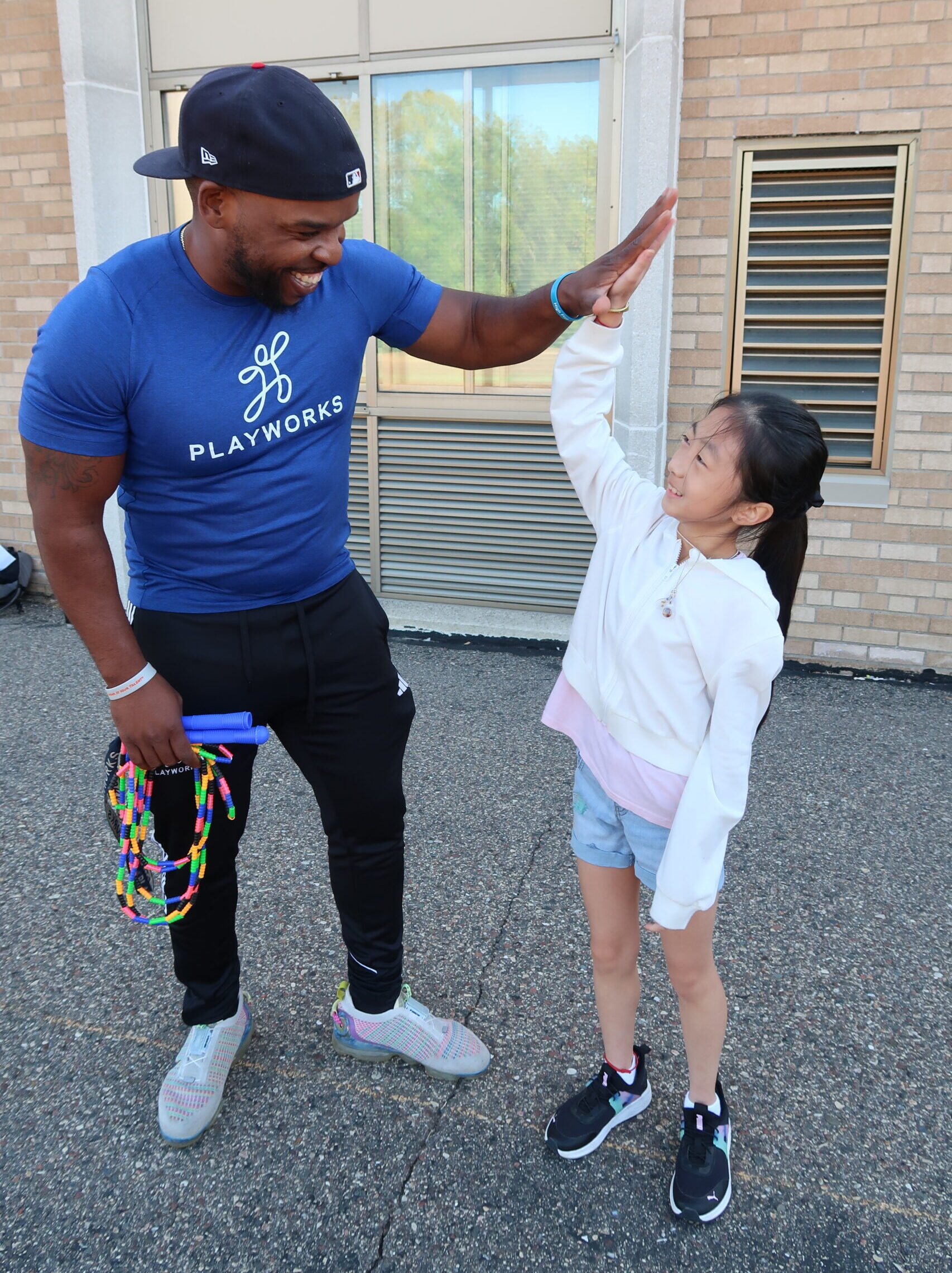 Isaiah high-fiving student