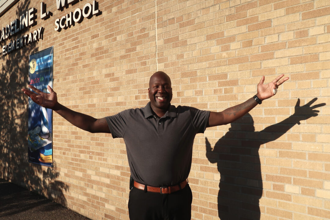 Mr. Watkins standing outside school