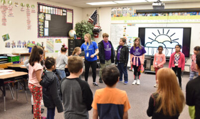 students and coach in classroom