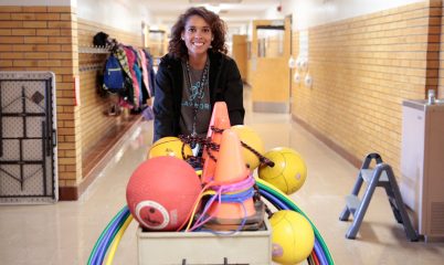 Teacher pushing equipment cart