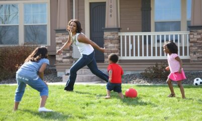 parent playing with kids outside