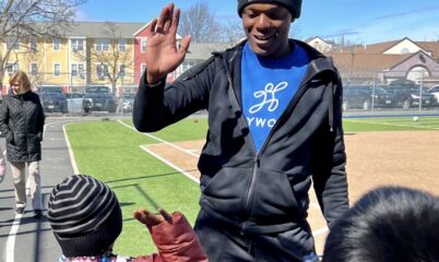 Coach Q giving a student a high-five