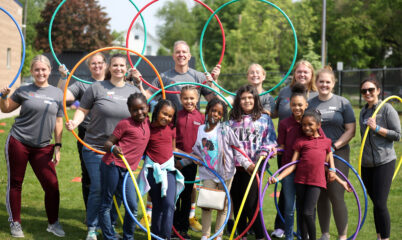 kids and adults posing with hula hoops
